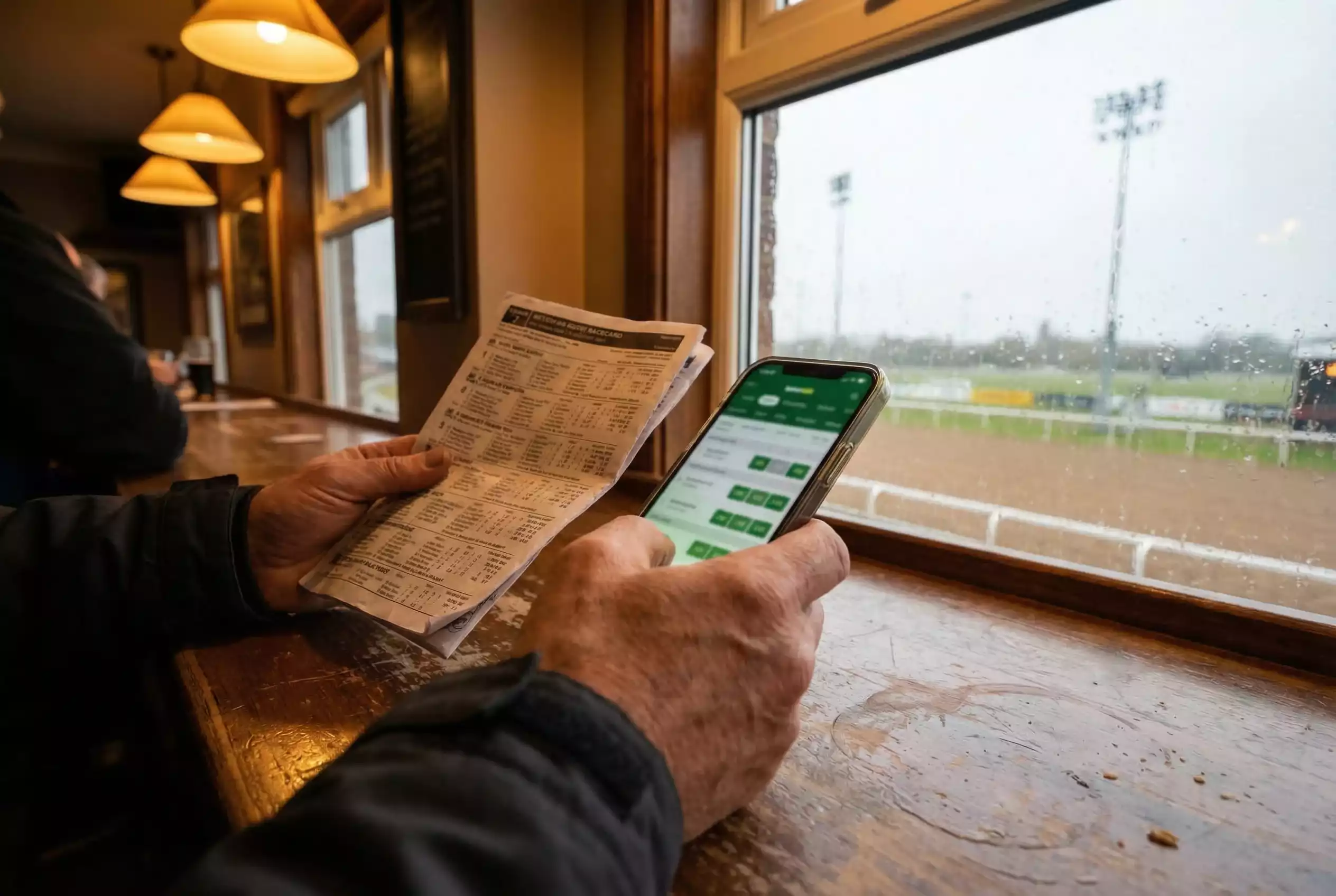 Punter studying a racecard before placing a bet at Wolverhampton racecourse
