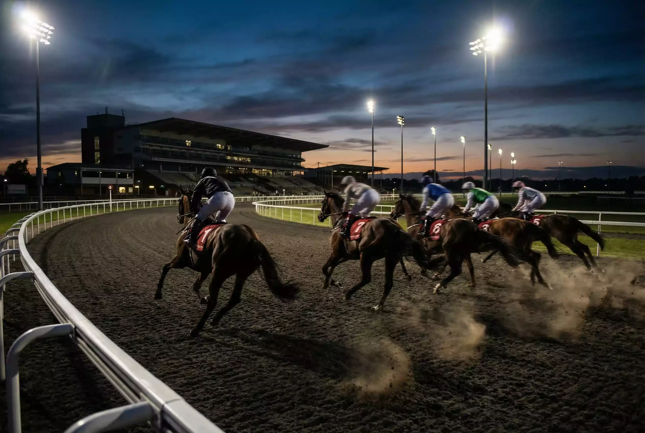Horses breaking from starting stalls for a one-mile race at Wolverhampton