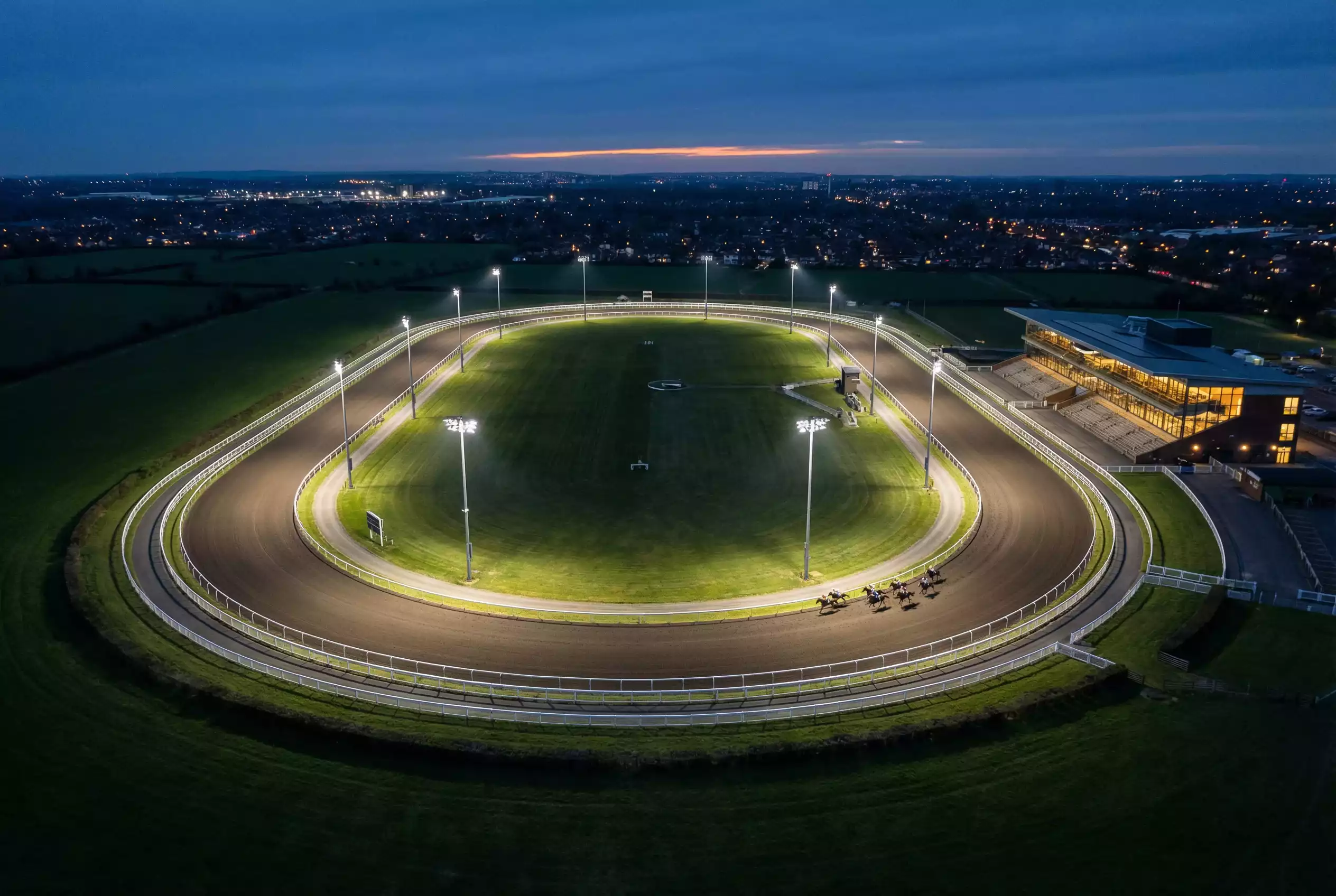 Aerial view of Wolverhampton all-weather racecourse with Tapeta track and floodlight pylons