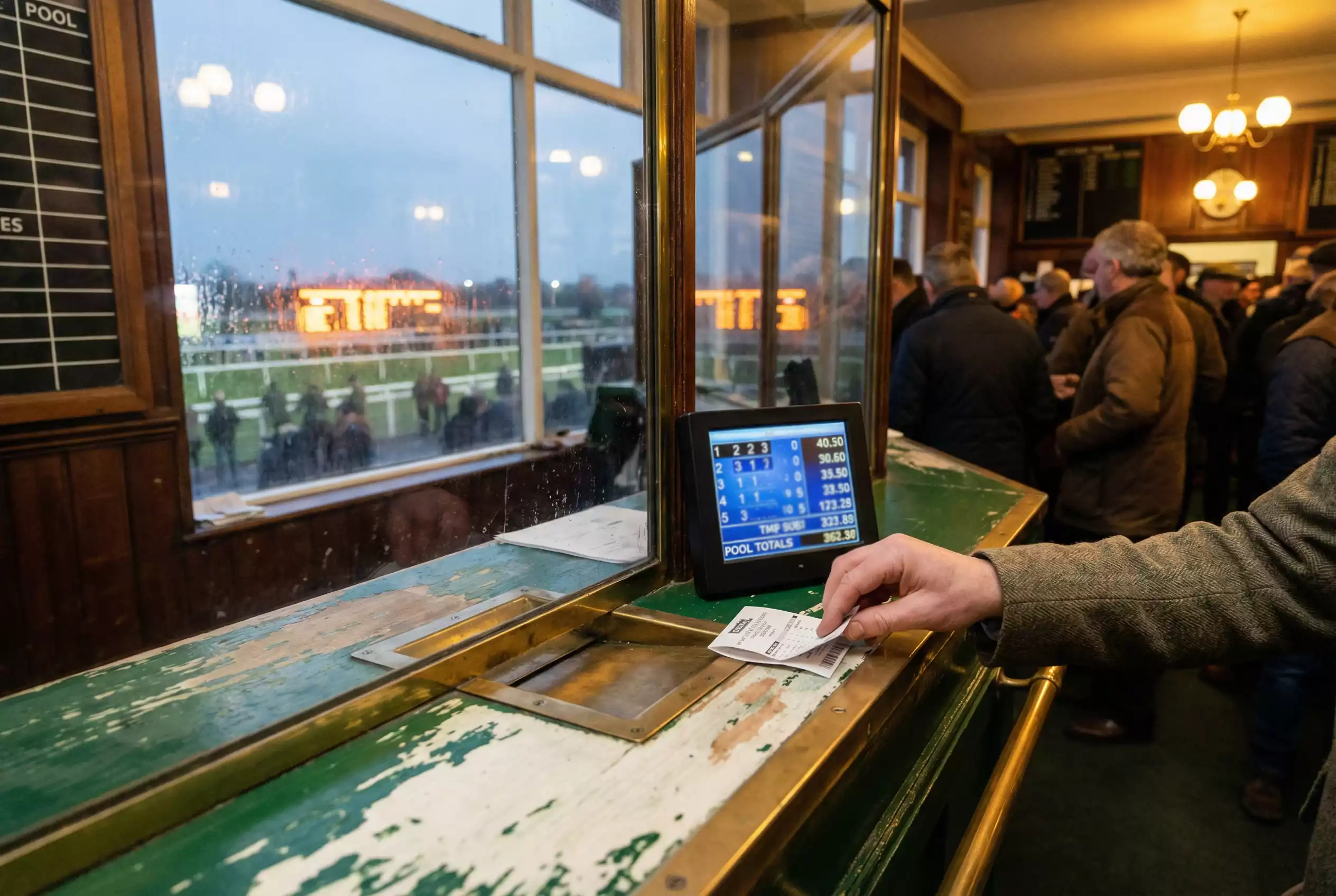 Tote betting counter at a British racecourse with pool odds displayed